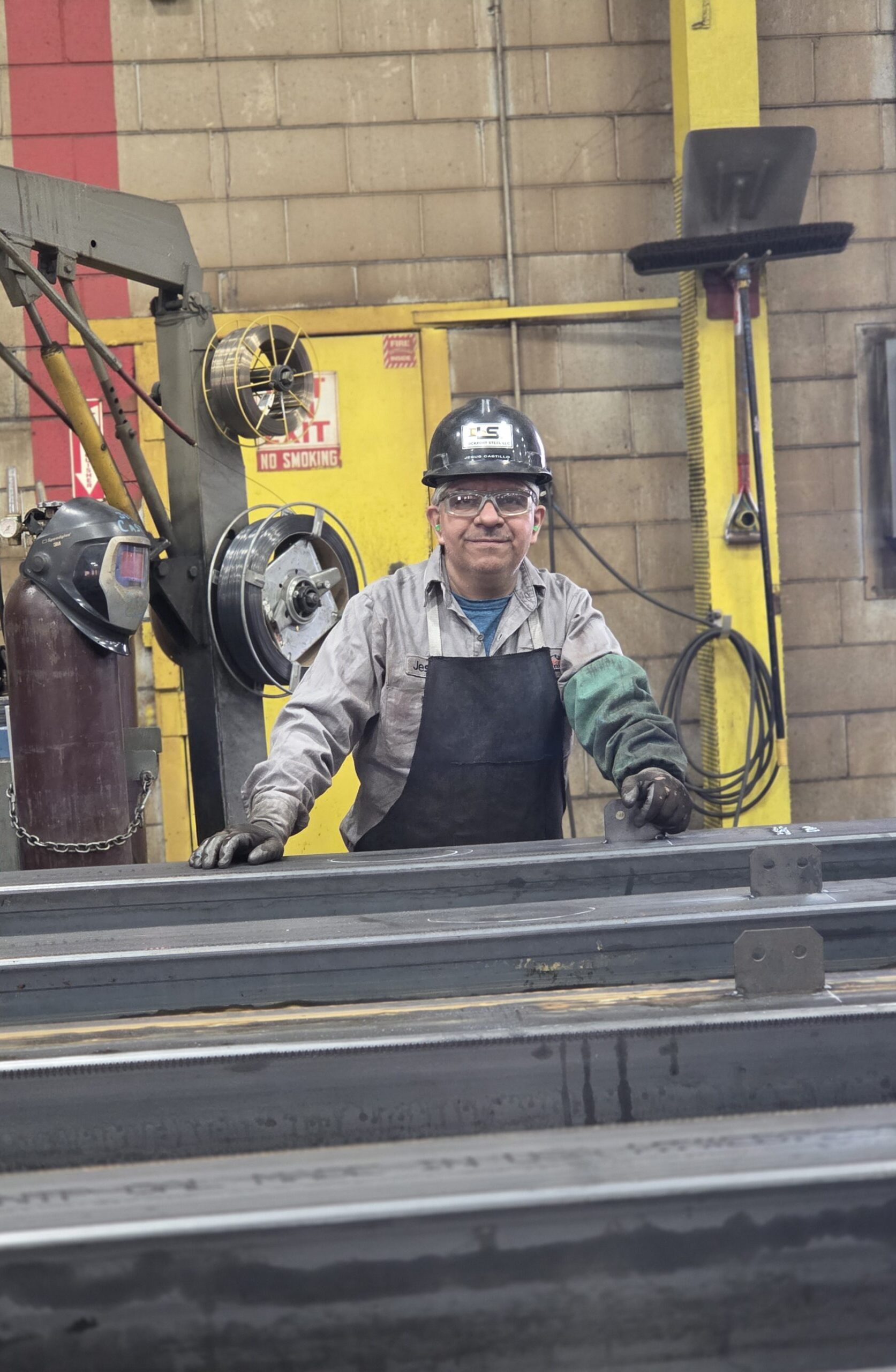 A smiling metal fabrication expert working in Lockport's production facility.